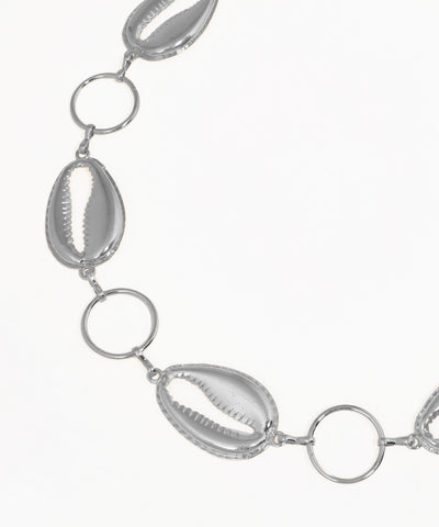 Silver necklace with shell-like beads on a white background