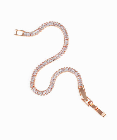 Rose gold bracelet with clear gemstones on a white background
