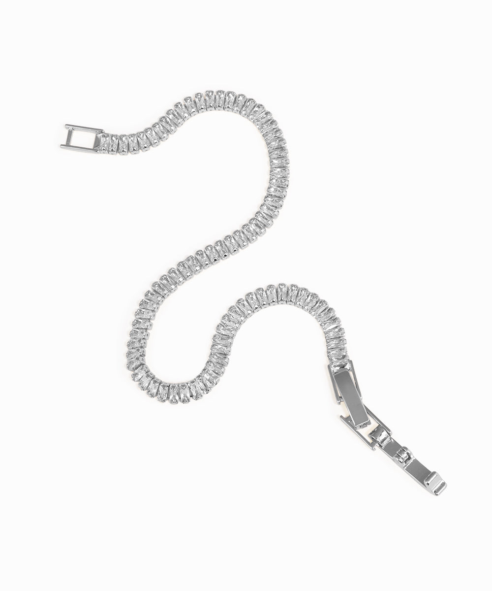 Silver bracelet with clear gemstones on a white background