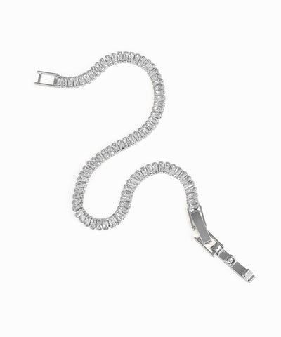 Silver bracelet with clear gemstones on a white background