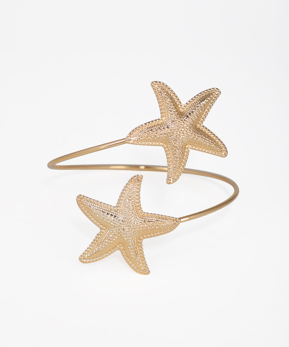 Gold starfish bracelet on a white background