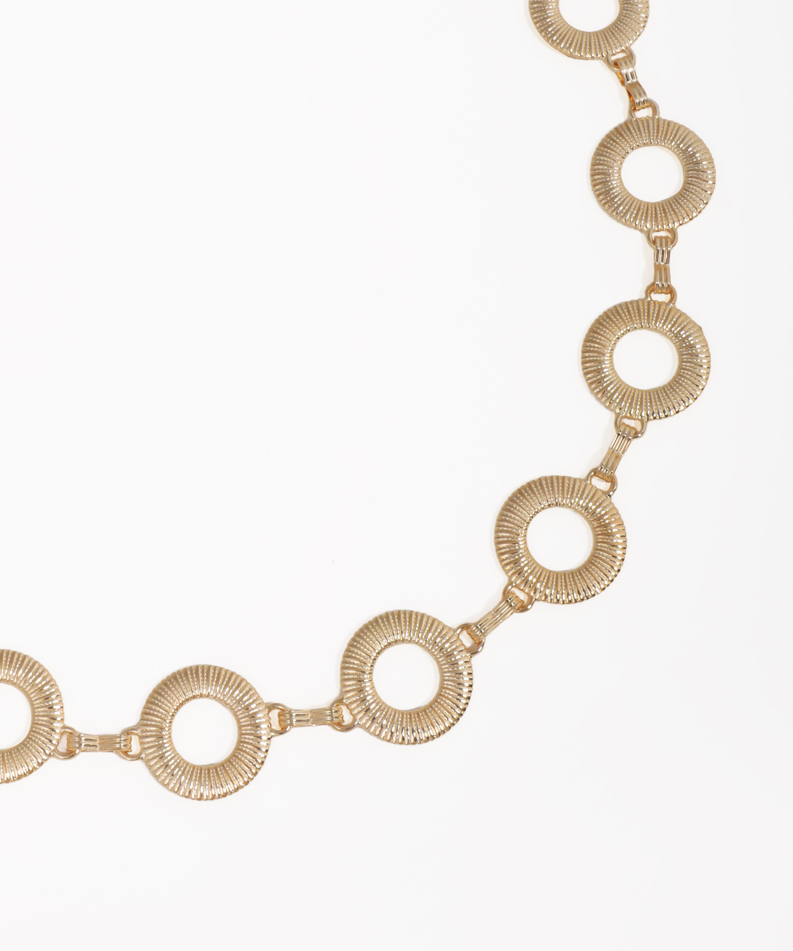Gold necklace with circular links on a white background