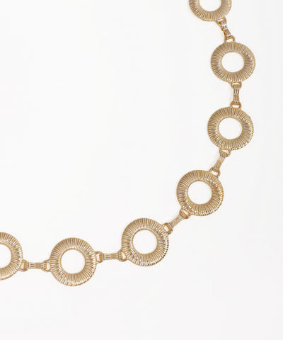 Gold necklace with circular links on a white background
