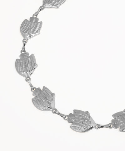 Silver bracelet with leaf-shaped links on a white background