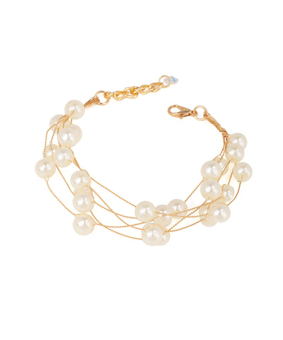 Gold-tone multi-strand bracelet with cream faux pearls and an adjustable closure