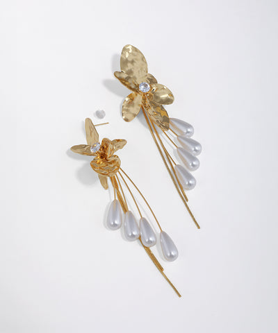 Gold-tone floral drop earrings with hammered texture, clear CZ, and multiple strands of faux pearl drops.