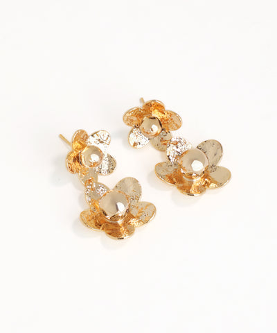 Gold floral earrings on a white background