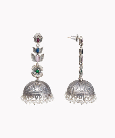 Oxidized silver-tone drop earrings with colorful floral motifs, green center crystal, and faux pearl jhumka bells.