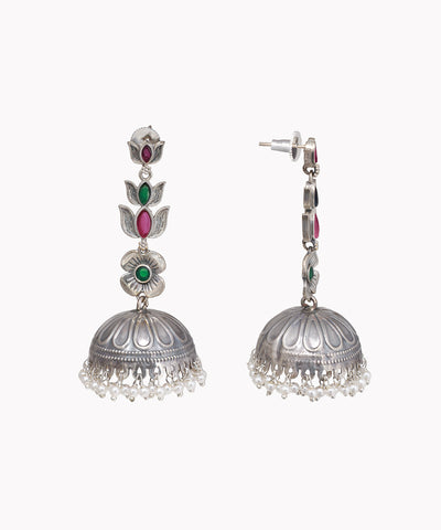 Pair of silver jhumka earrings with gemstones on a white background
