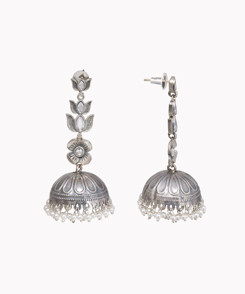 Pair of silver jhumka earrings on a white background