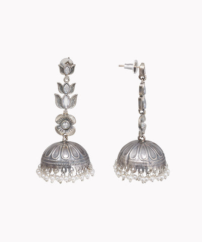 Pair of silver jhumka earrings on a white background