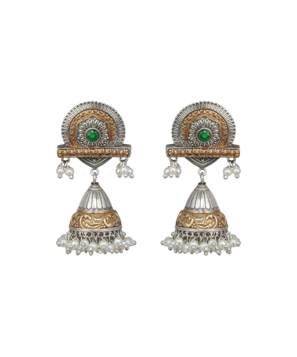 Pair of ornate earrings with gold and silver design on a white background