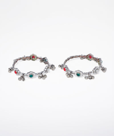 Pair of hoop earrings with colorful gemstones on a white background