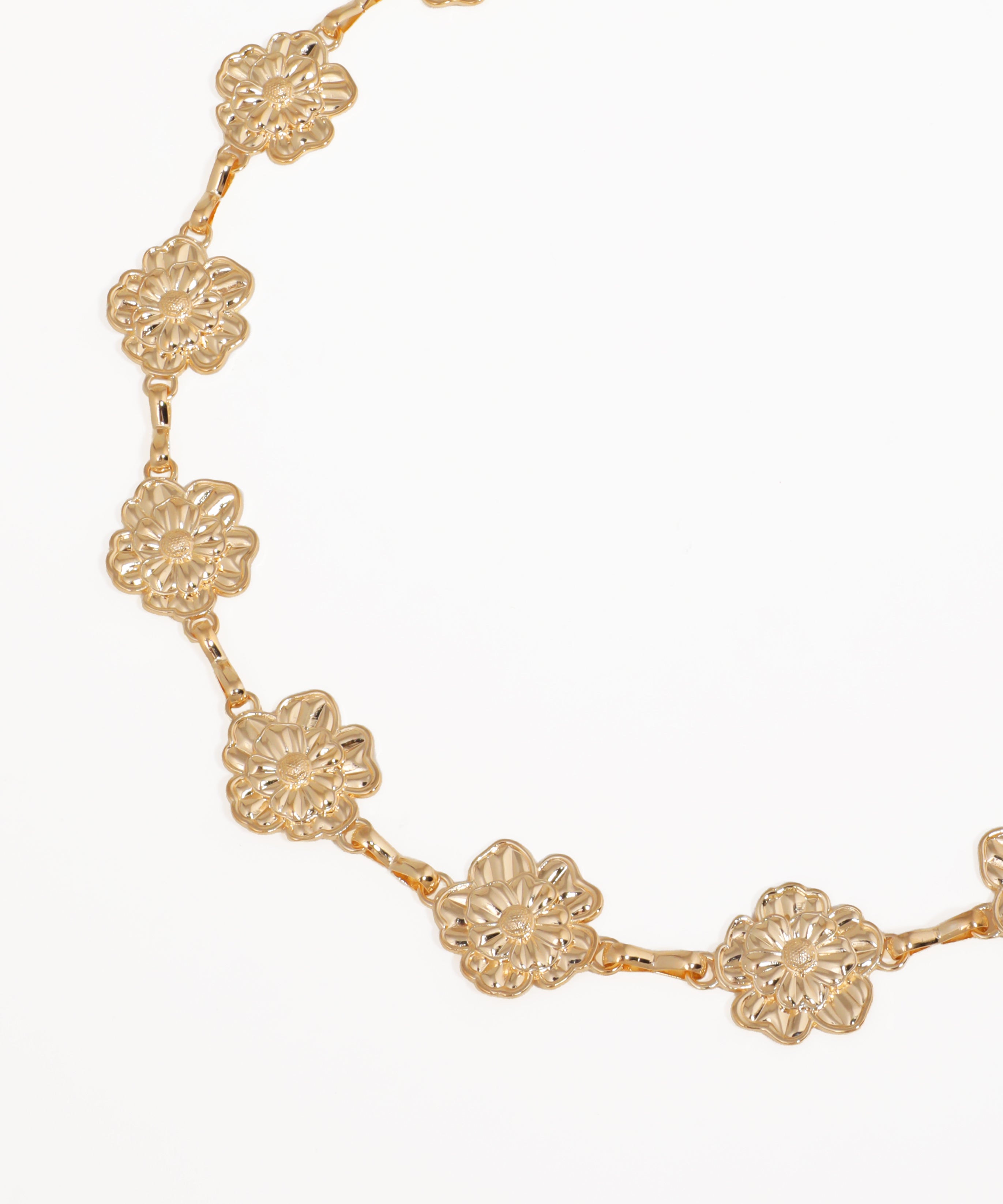 Gold floral necklace on a white background