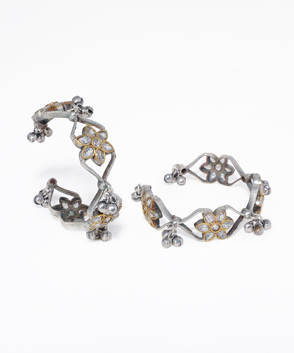 Pair of floral hoop earrings on a white background