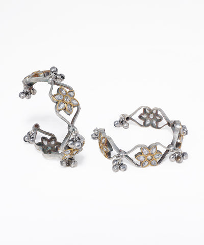 Pair of floral hoop earrings on a white background