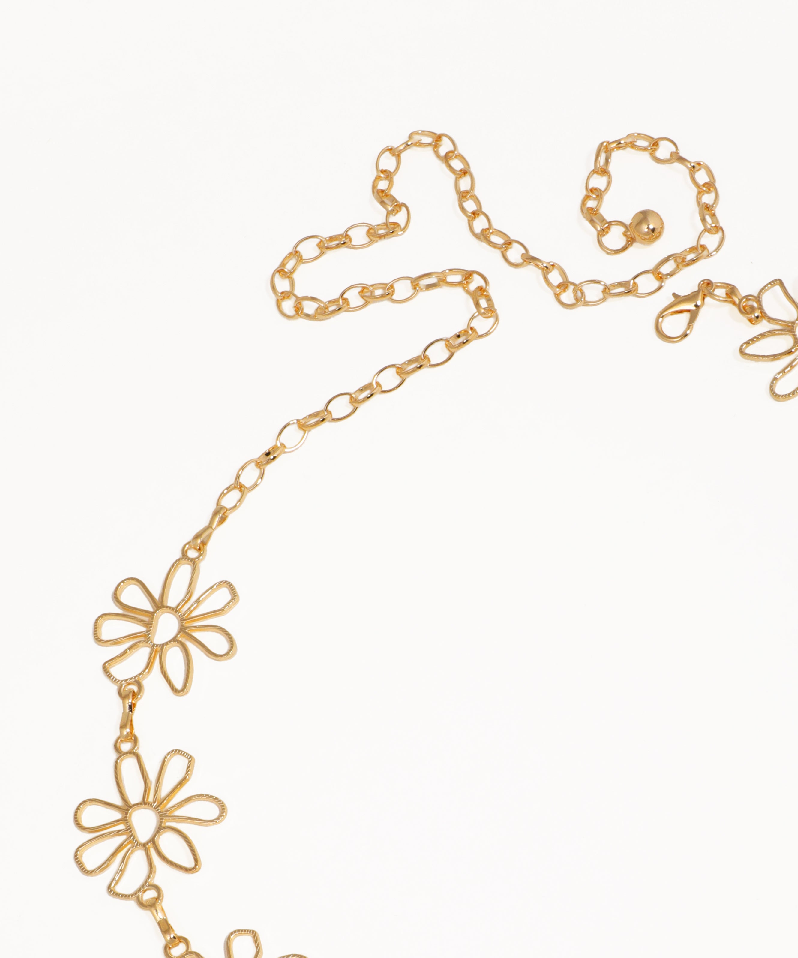 Gold chain necklace with floral pendants on a white background