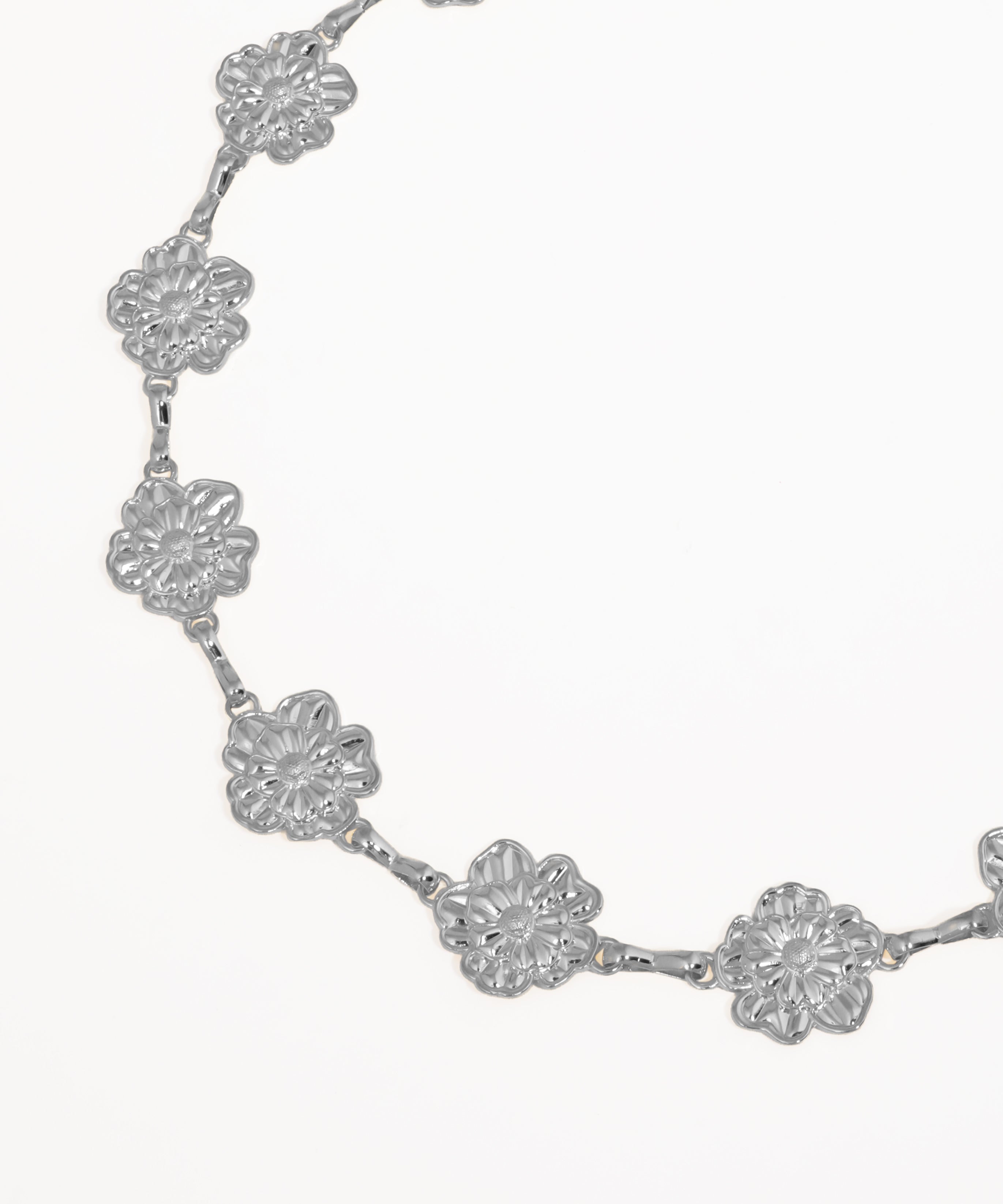 Gold floral necklace on a white background
