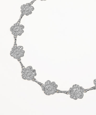Gold floral necklace on a white background