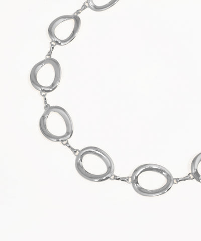Silver necklace with oval links on a white background