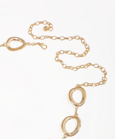 Gold necklace with interlocking oval pendants on a white background
