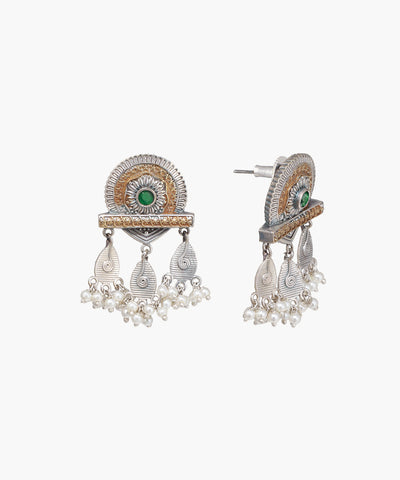 Ornate earrings with green gemstones and pearl-like elements on a white background