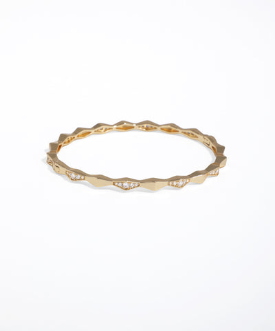 Gold ring with a textured band on a white background