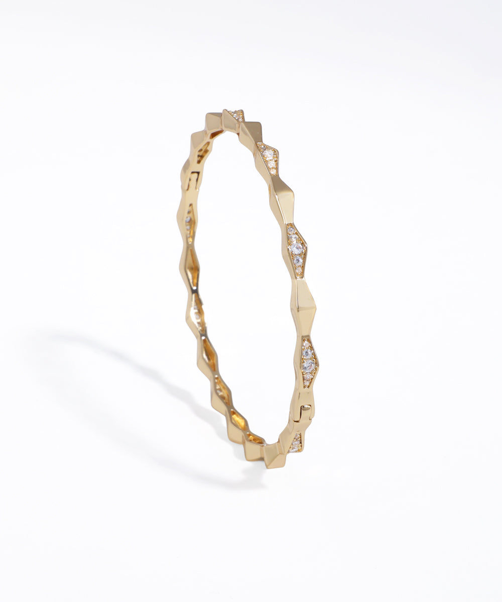 Gold-tone bracelet with geometric faceted links and clear CZ stones