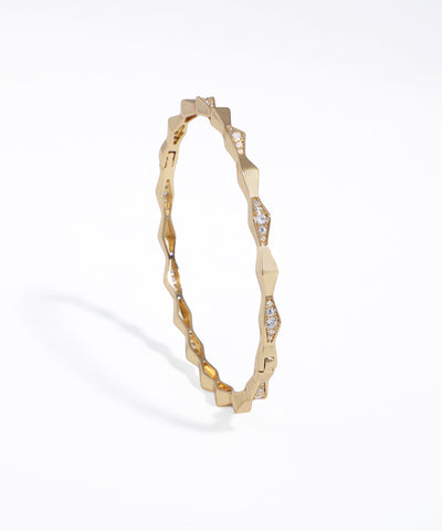 Gold-tone bracelet with geometric faceted links and clear CZ stones