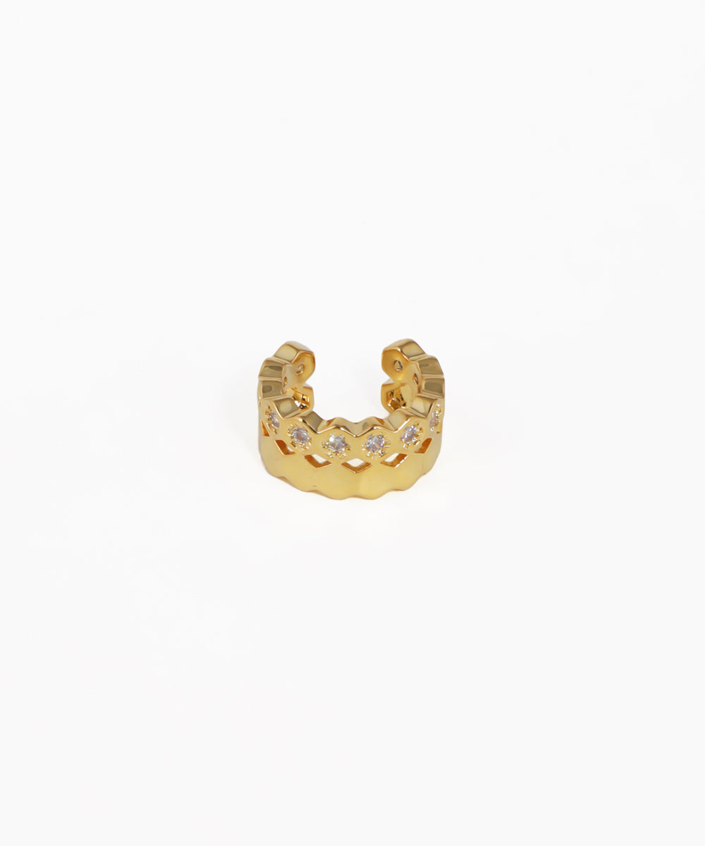Gold ring with embedded stones on a white background