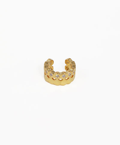 Gold ring with embedded stones on a white background
