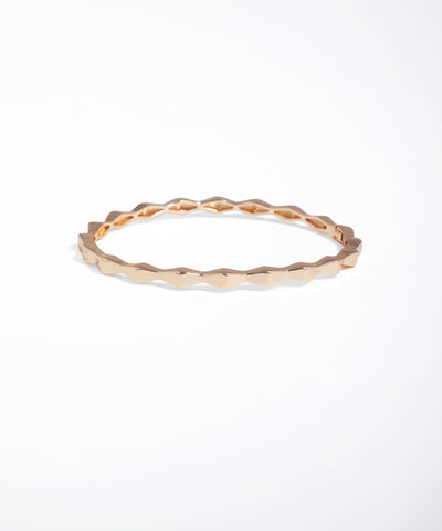 Rose gold ring with a textured band on a white background