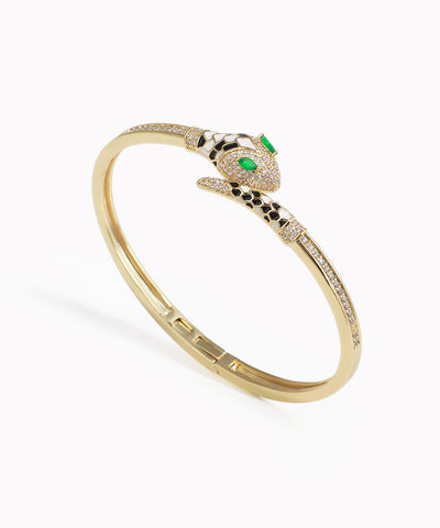 Gold-tone bracelet with paved serpent head, clear CZ stones, green eyes, and black & white enamel accents