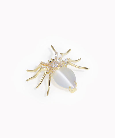 Gold-tone spider brooch with iridescent white body stone and clear CZ accents