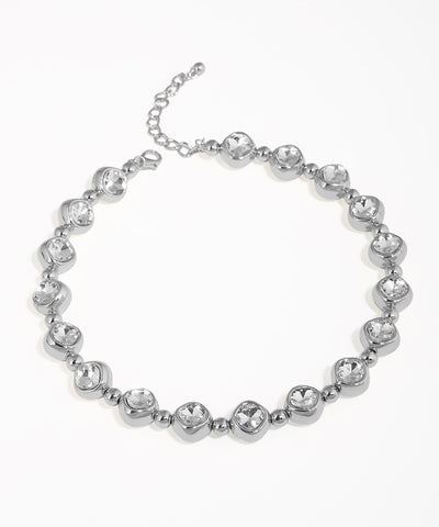 Silver bracelet with clear gemstones on a white background