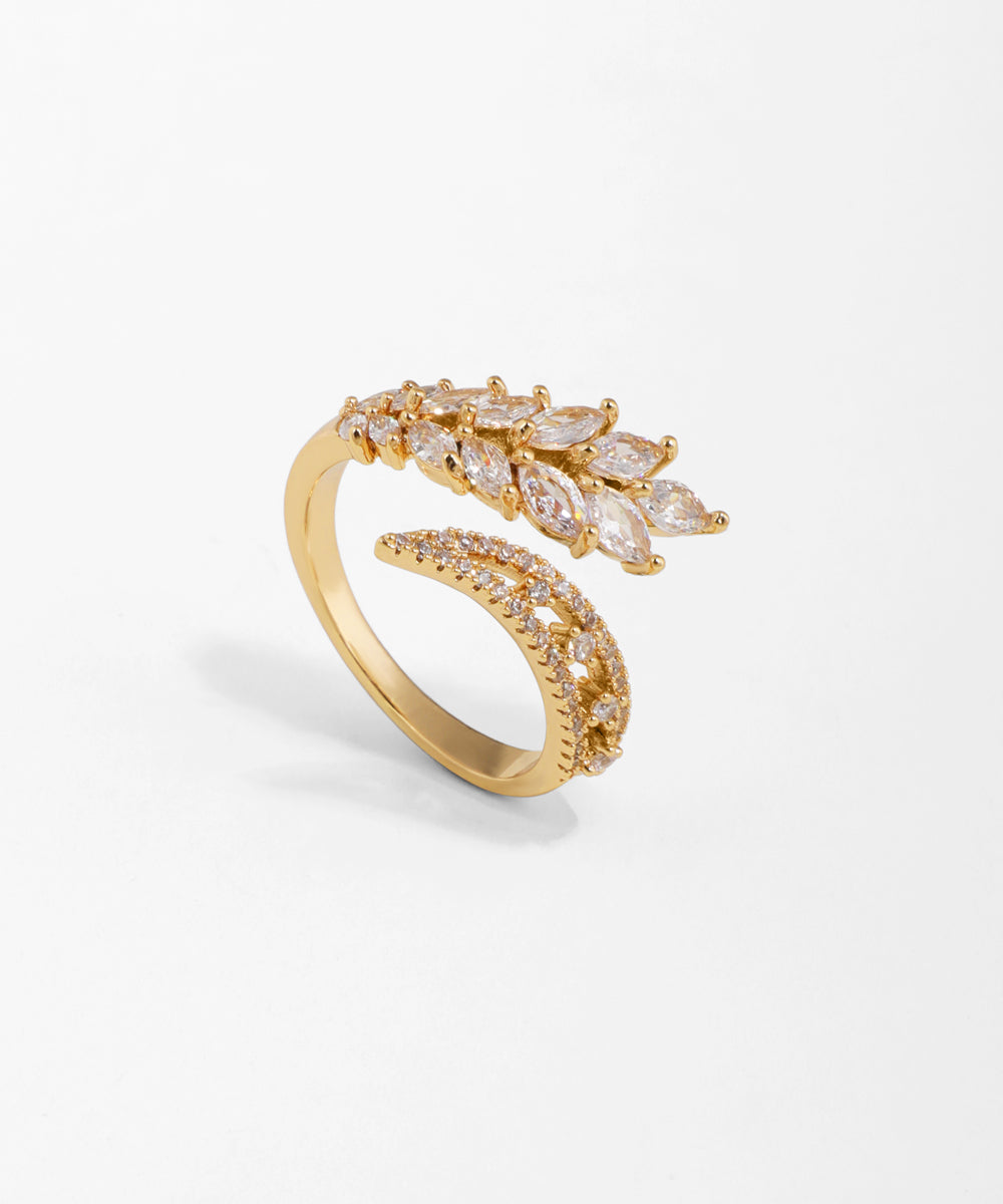 Gold ring with diamond accents on a light gray background