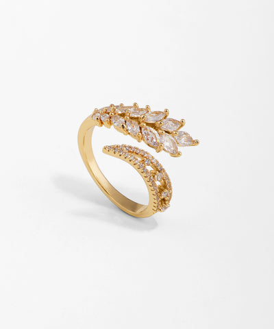 Gold ring with diamond accents on a light gray background