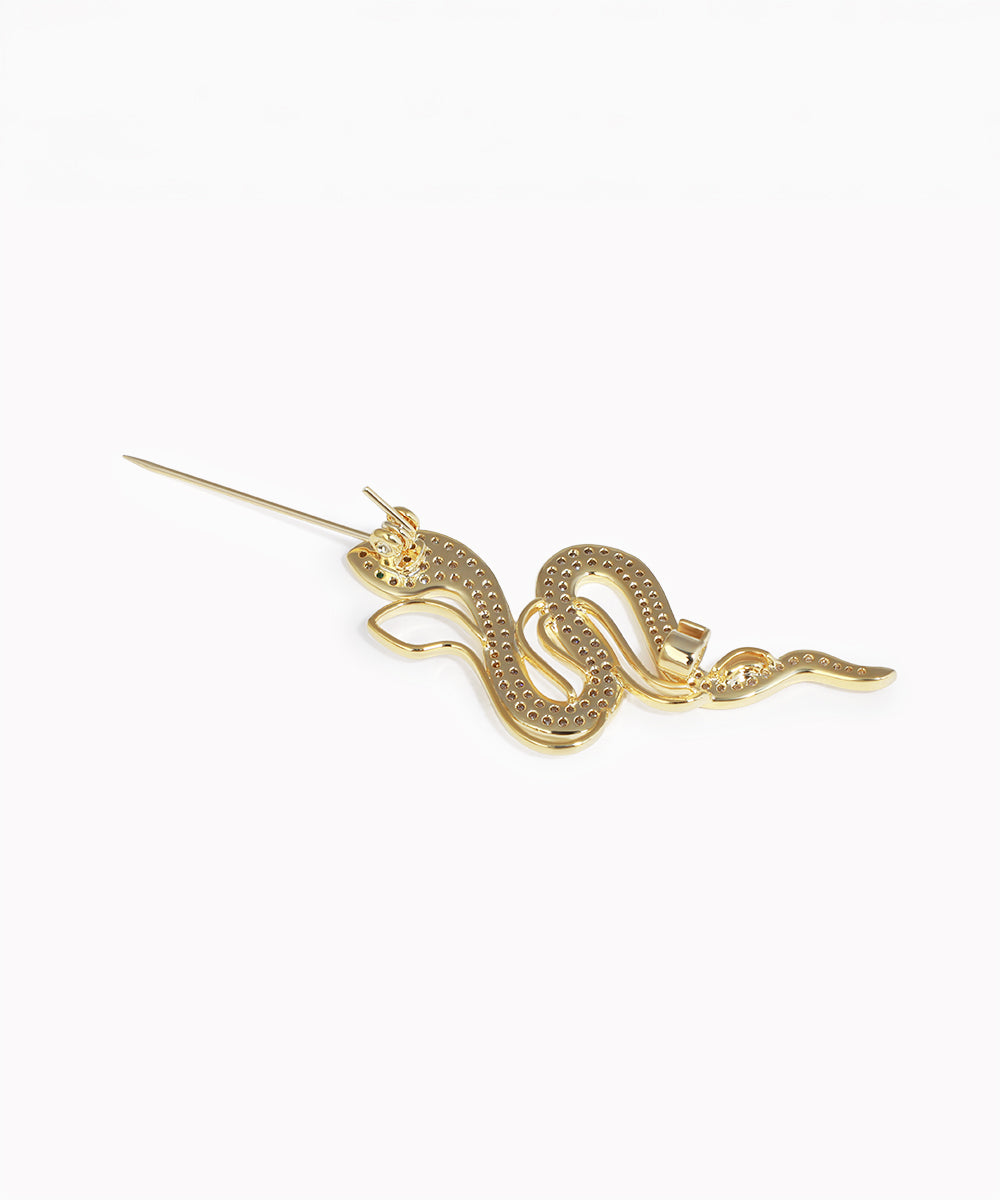 Gold snake-shaped hairpin on a white background
