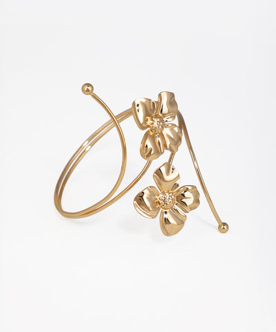 Gold floral hoop earring on a white background