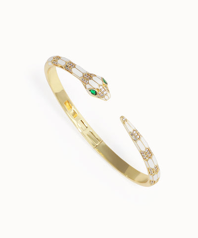 Gold bracelet with emerald stones on a white background