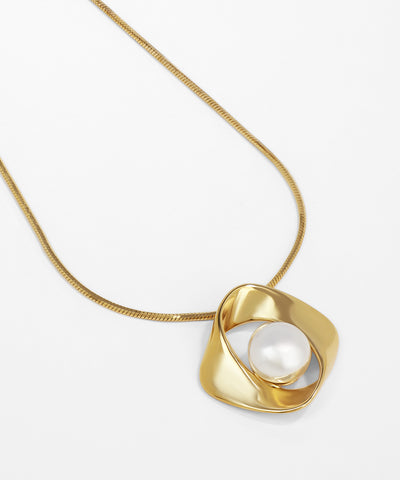 Gold necklace with a pendant featuring a pearl on a white background