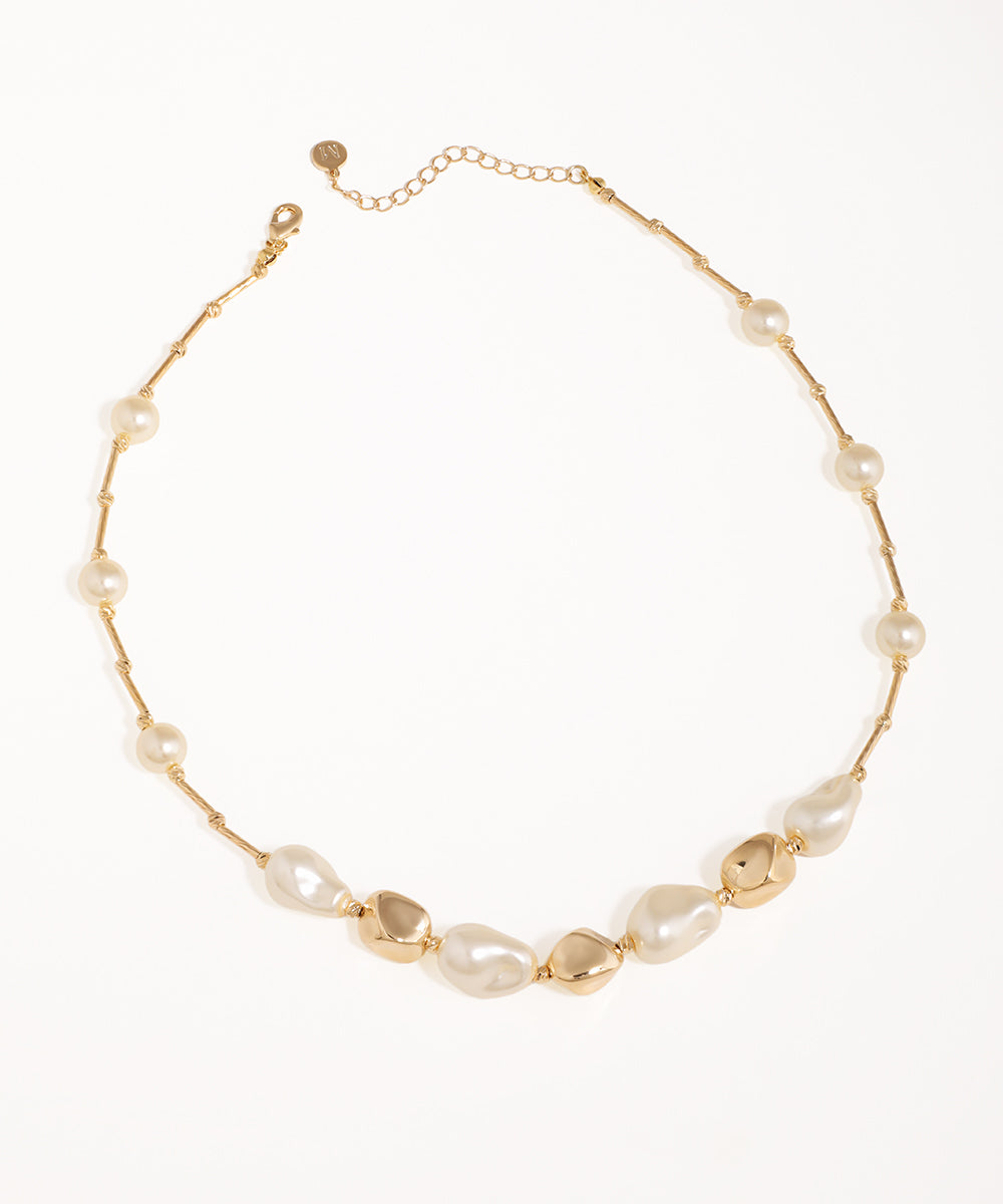 Gold-tone necklace with irregular faux pearls and organic metallic links, featuring a lobster clasp and extender.
