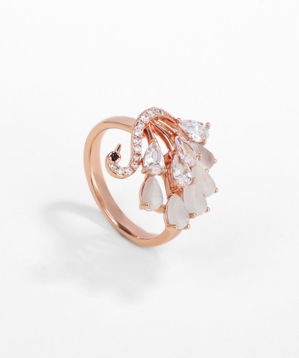 Rose gold ring with pear-shaped gemstones on a white background