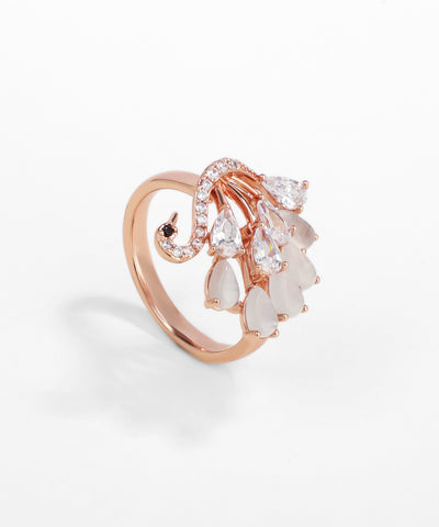 Rose gold ring with pear-shaped gemstones on a white background