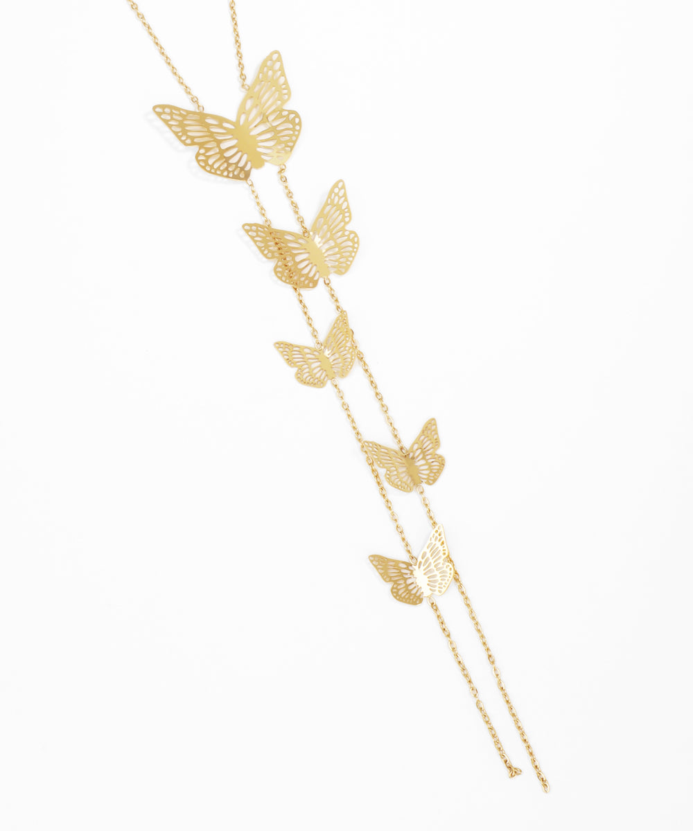 Gold butterfly necklace on a white background