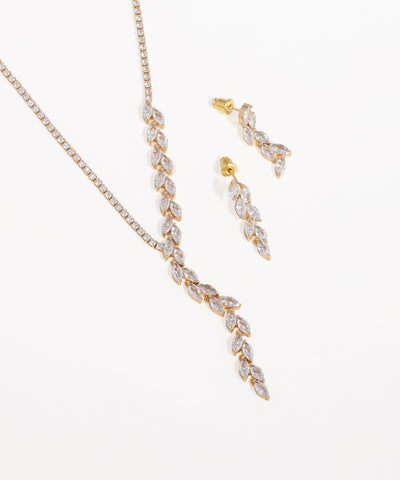 Gold necklace and earrings set on a white background