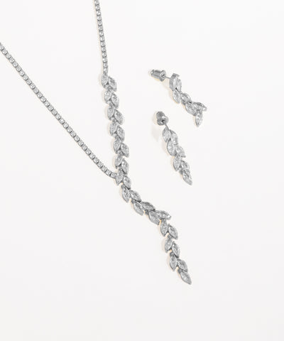 Silver necklace and earrings set on a white background