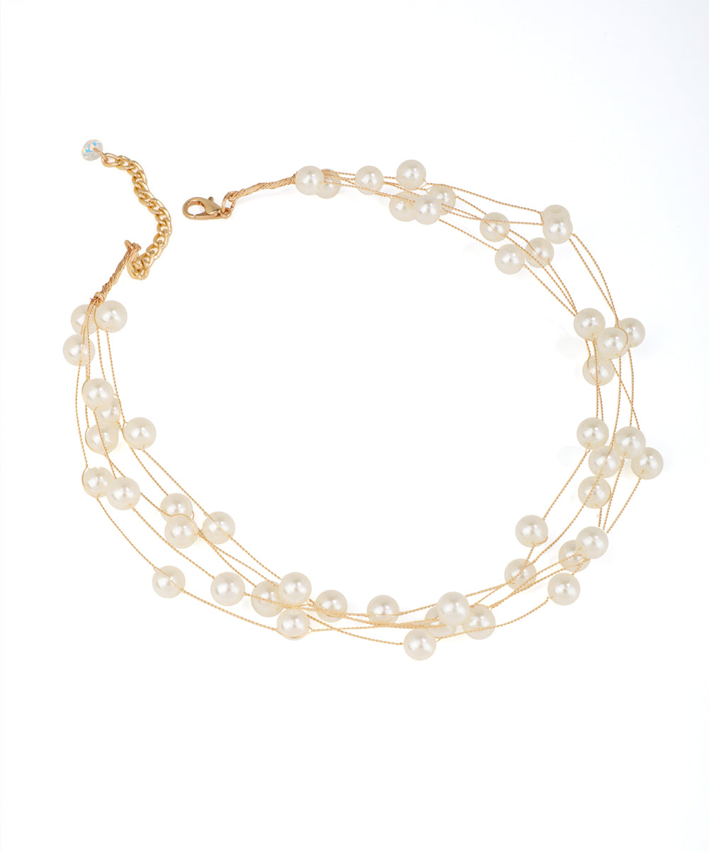 Gold-tone necklace with multiple strands of cream faux pearls and an extender chain.