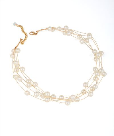 Gold-tone necklace with multiple strands of cream faux pearls and an extender chain.