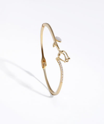 Gold-tone bracelet with sculpted tulip motif, white leaf accent, and line of clear CZ stones.